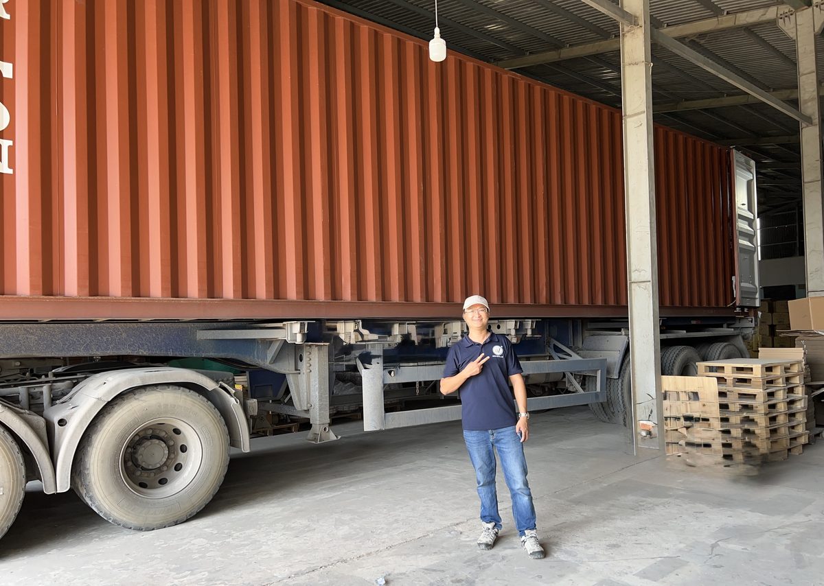 A 40 ft container being loaded with cartons of coffee wood dog chews at the WINVN INT warehouse.