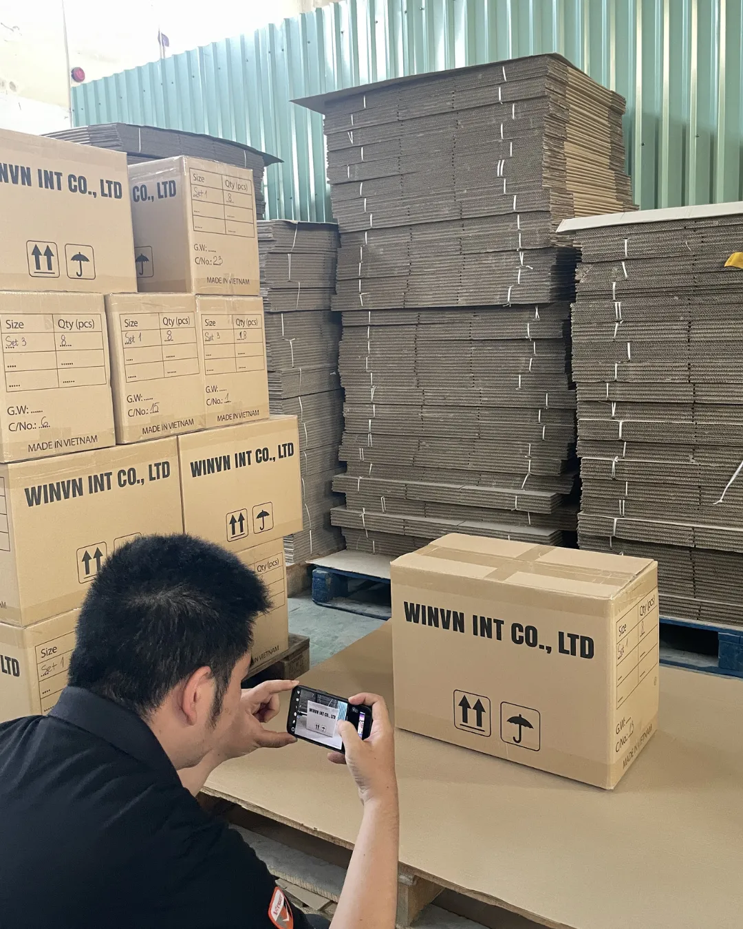 A WINVN INT worker checking a labelled master carton before it is loaded
