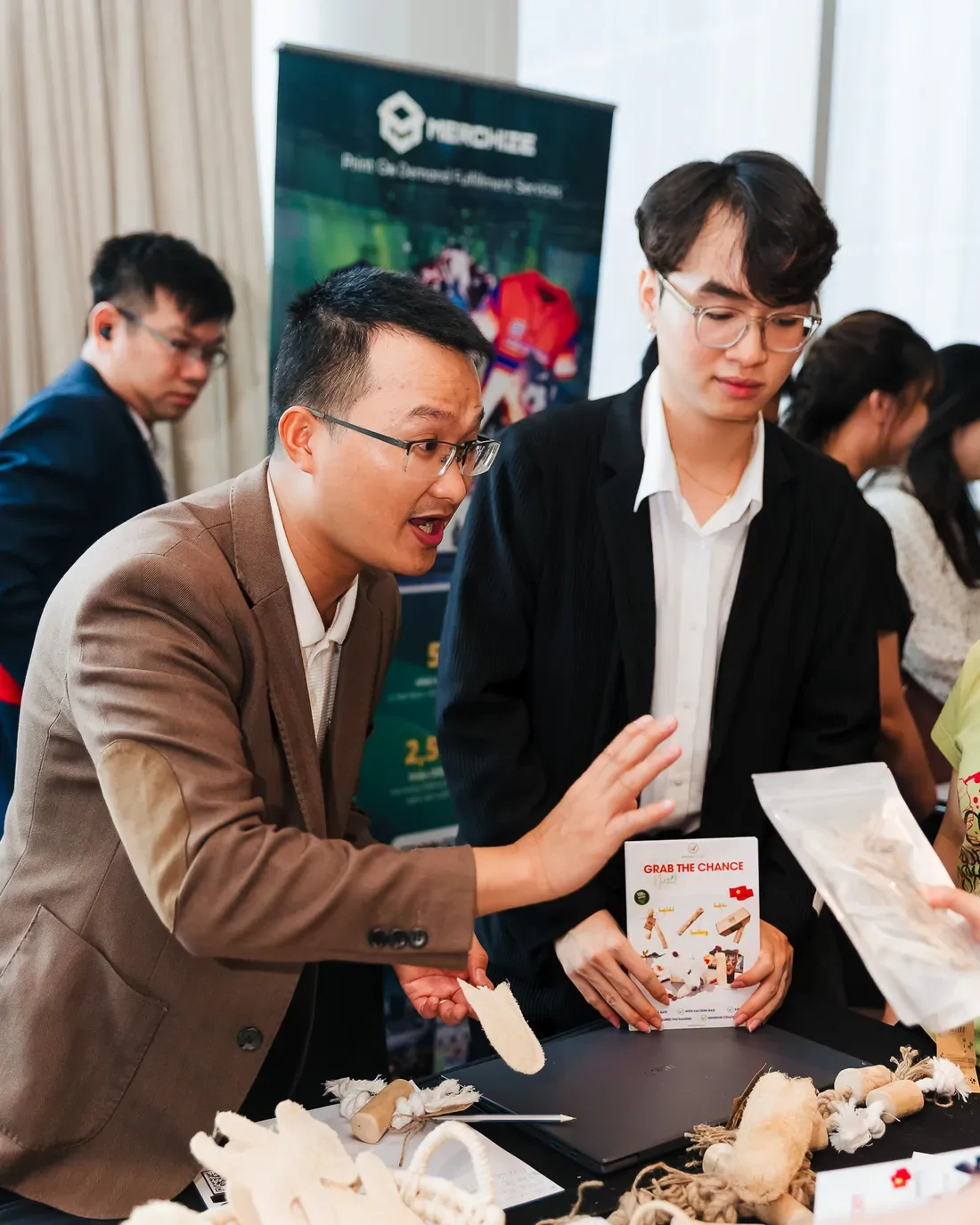 Mark Ton showing coffee wood chews to visiting buyers at a pet trade fair