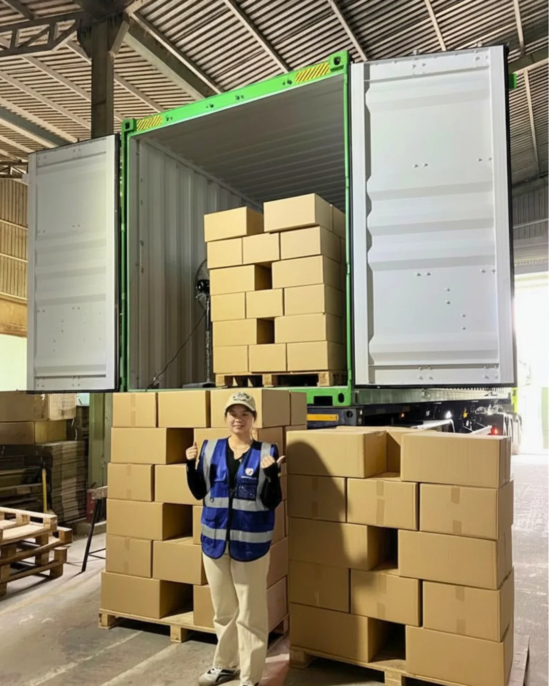 WINVN INT staff checking pallet height against the container door before loading