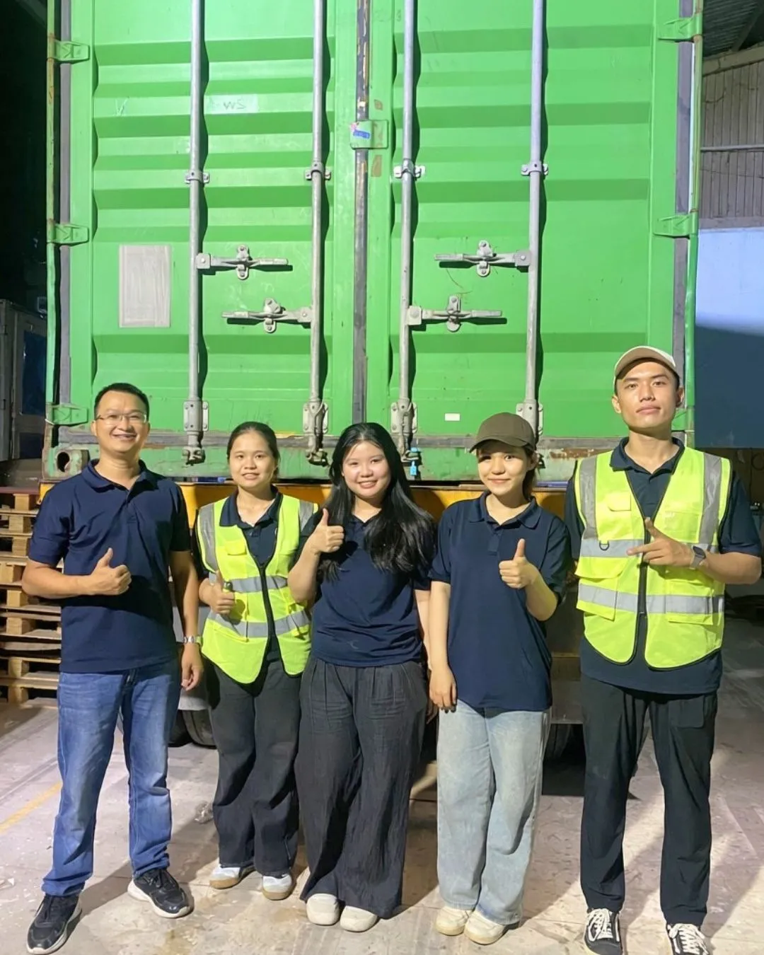 The WINVN INT team in front of a loaded export container before it leaves the warehouse