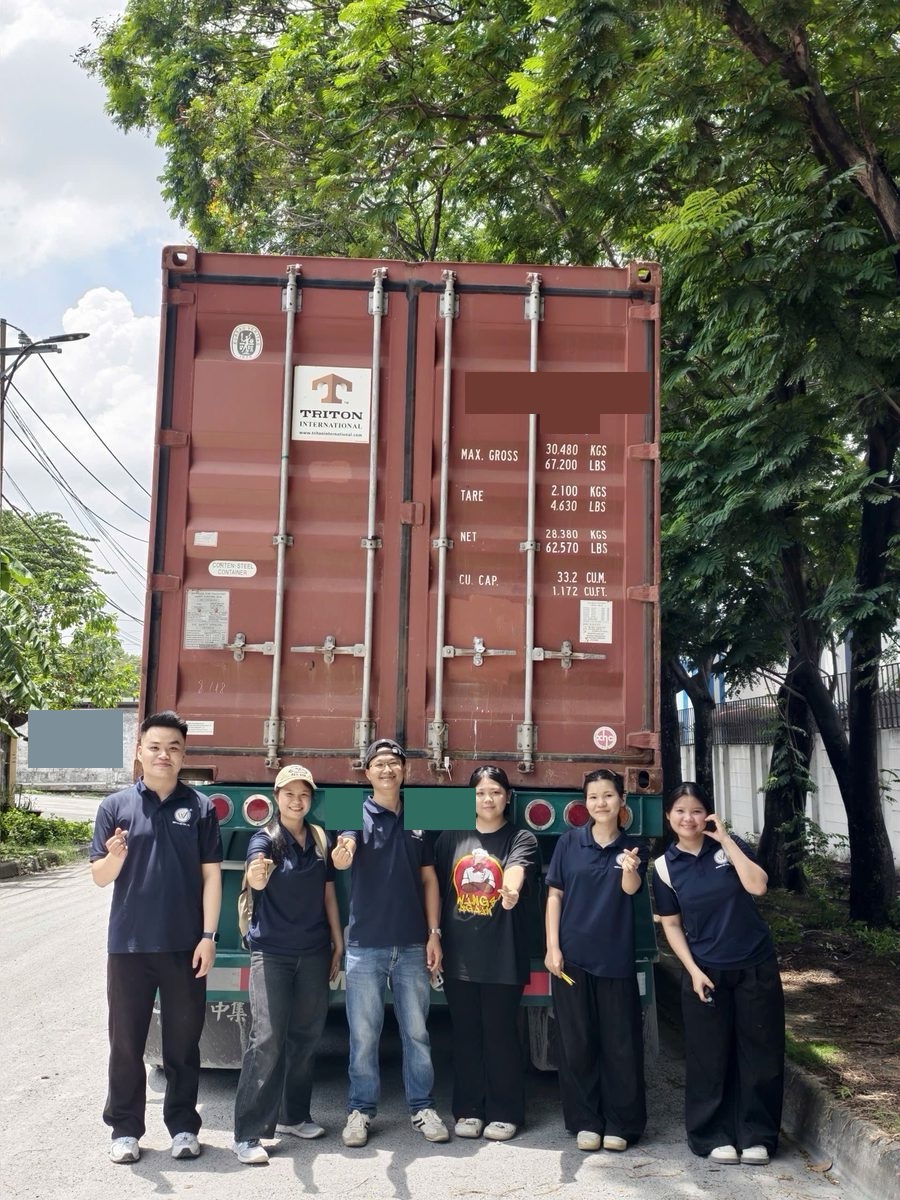 The WINVN INT team in front of a container leaving for the port