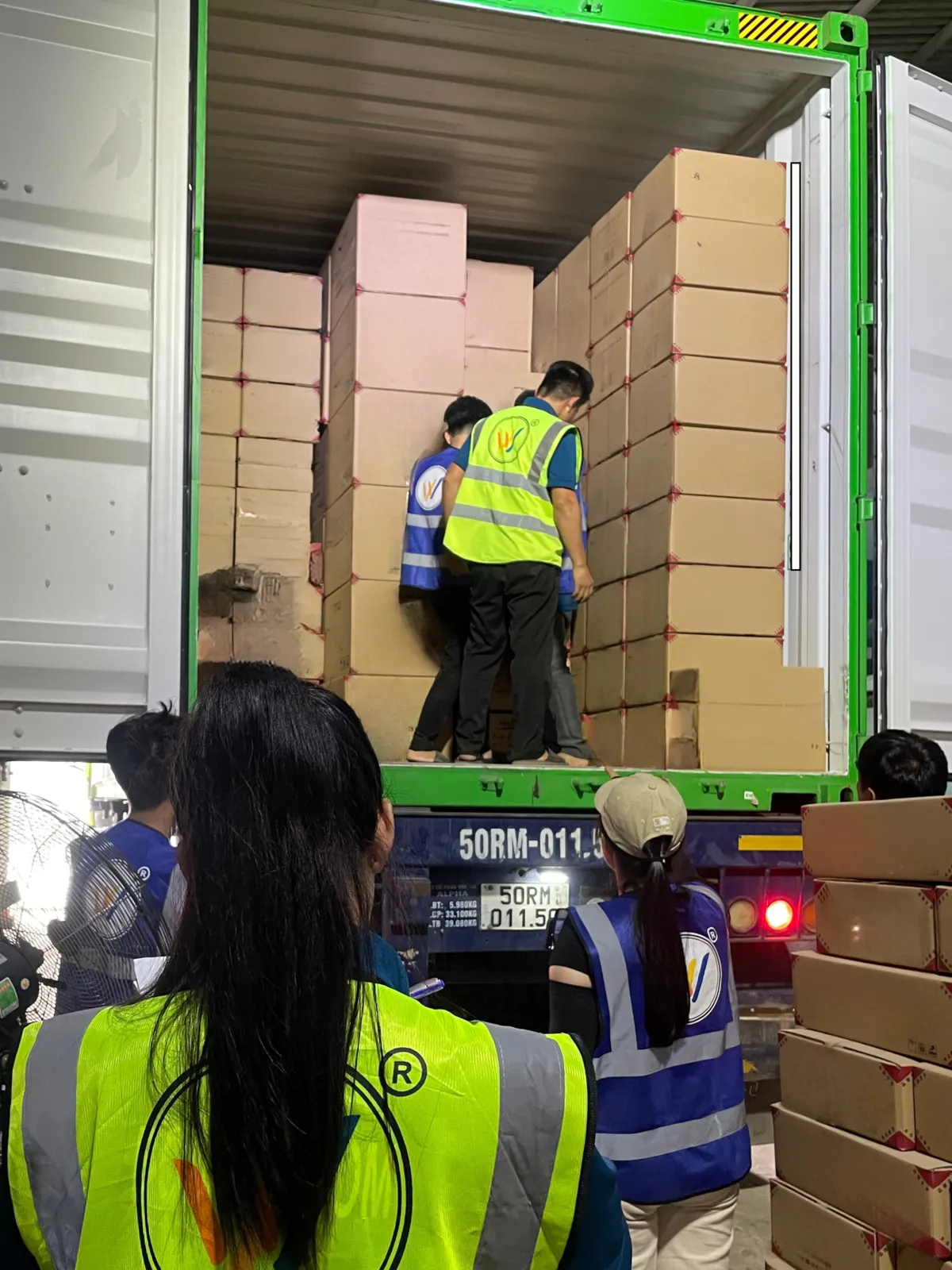The WINVN INT team loading master cartons into an export container